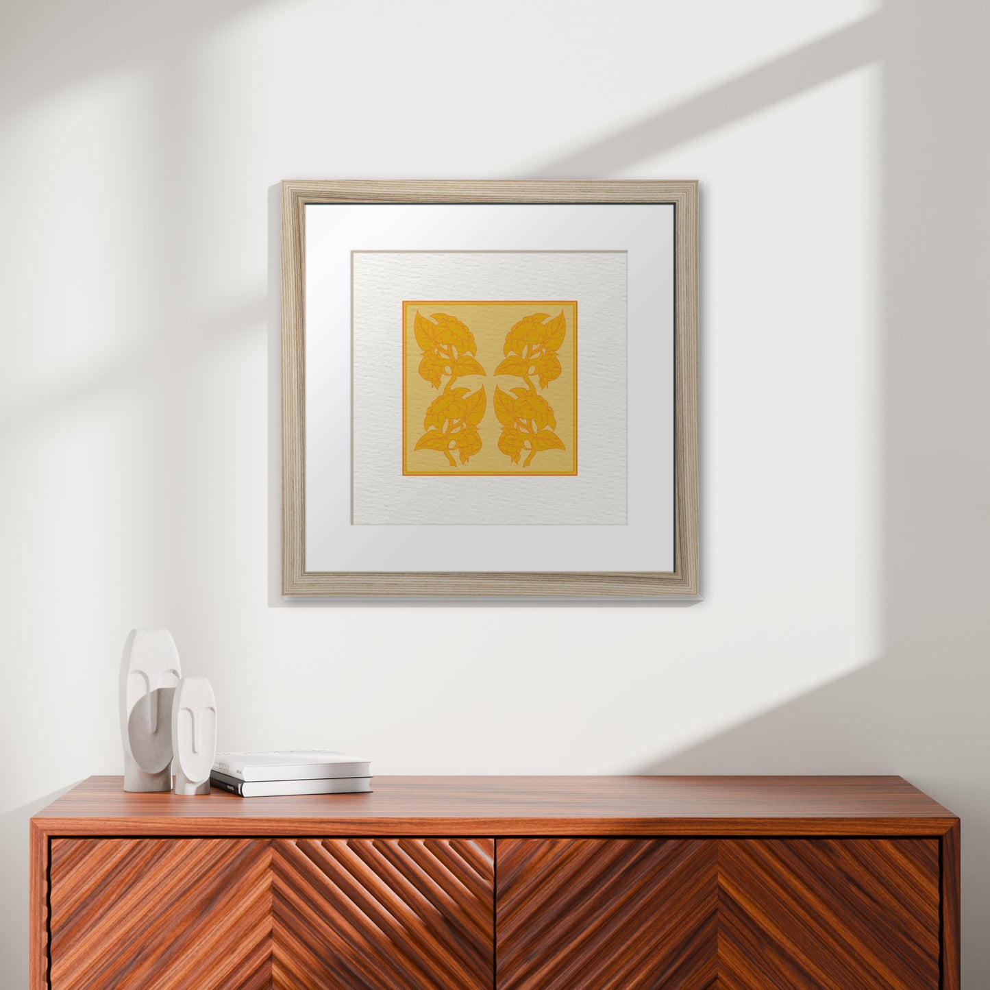 Framed Art Print - Sunflowers in Yellow & Orange displayed above a modern wooden cupboard with decorative sculptures and books in a bright, minimalist room.