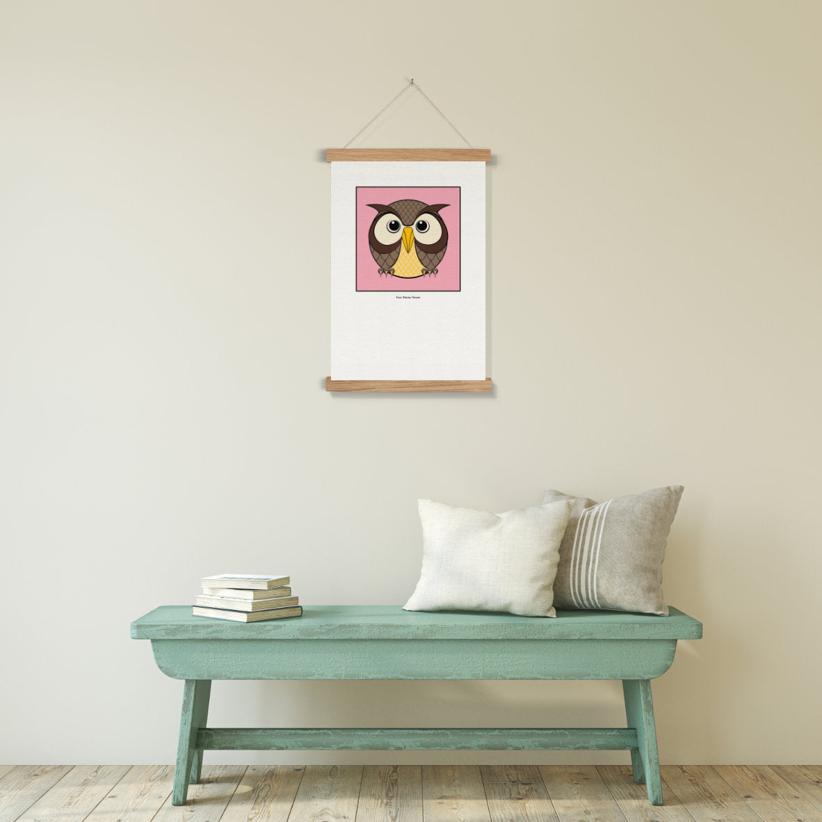 Original A2 Art Print - Owl featuring a stylized owl illustration with large eyes on a pink background, displayed above a rustic teal bench with cushions and books.